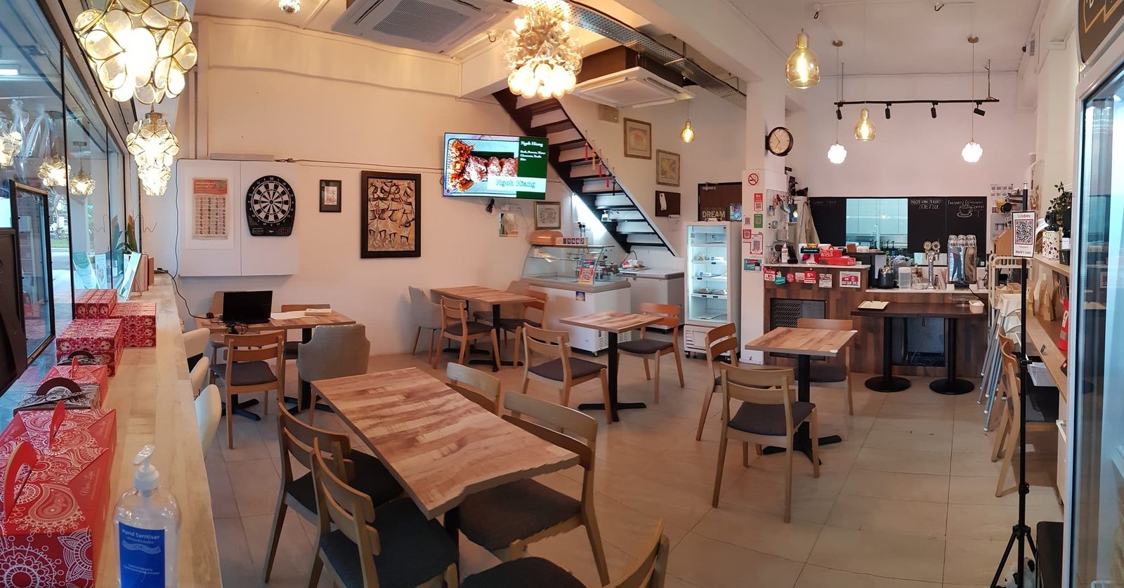 Interior of Marie's Lapis Cafe featuring cozy café seating, warm lighting, and inviting dessert display area